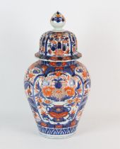 A Japanese Imari oviform vase with domed cover and knop finial, decorated with bold floral designs,