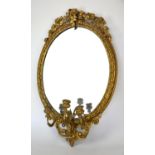 Giltwood and gesso oval girandole mirror, late 19th Century, with foliate cresting,