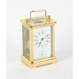 French brass carriage clock, with white enamel dial with Roman and Arabic numeral chapter ring,