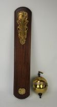 Thwaites and Reed brass gravity clock, with mahogany wall mount, no 390, engraved to base name