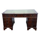 Mahogany pedestal desk, 20th Century, the top with green leather lined writing surface,