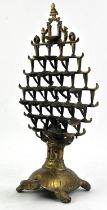 A brass butter lamp, possibly Indo Tibetan, modelled as a tortoise carrying a tiered set of lamps
