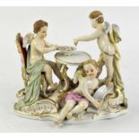 Late 19th century Meissen fortune teller group of three cherubs, at a table, one blindfolded