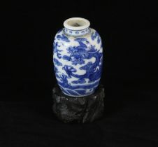 A small blue and white oviform vase, decorated with a dragon above waves, the base unglazed; 5 cm
