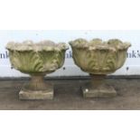 Pair of reconstituted stone urns, moulded with leaves, H42cm