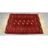 Bokhara rug, 20th century, woven with 5 lozenges within geometric borders in brick red,