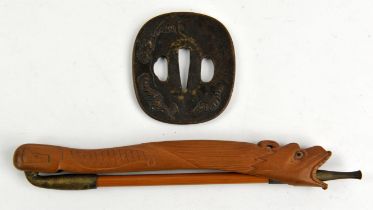 A soft metal tsuba with two hitsu ana, decorated with a dragon in takabori, unsigned, 7.