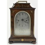 A Regency/William IV rosewood and brass inlaid mantel clock by Purvis. The case of architectural