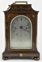A Regency/William IV rosewood and brass inlaid mantel clock by Purvis. The case of architectural
