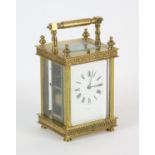 French brass carriage clock, 19th Century, the case with four finials, with grilled decoration in