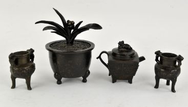 Four bronze objects, presumably for the table of the Scholar or Literati, comprising: a tripod