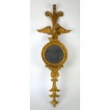 Carved and giltwood mirror, 20th Century, with a spread eagle and feather cresting,