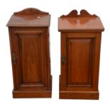 A matched pair of Edwardian walnut bedside cabinets, with differing crestings, above panelled doors