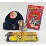 An assortment of Pokémon merchandise and accessories Includes: Ash & Pikachu hat, Comb Pack,