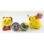 An assortment of Pokémon merchandise Includes: 2 Pikachu plushies (one Christmas Pikachu) and 2
