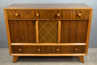 Conway Furnishers Ltd, a beech and walnut sideboard, with two drawers above cupboard doors,