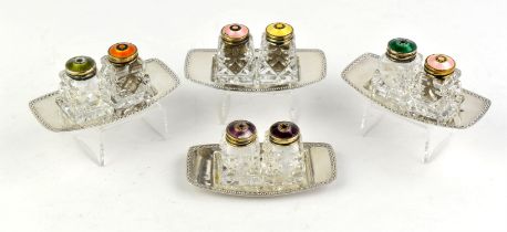 Four Norwegian silver and enamel cruet sets, 20th Century, each on silver plated stands (4)