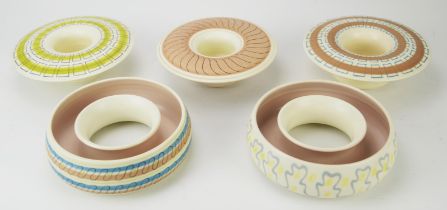 Poole pottery, three Freeform posy bowls and two flower rings, the bowls 18cm diameter,