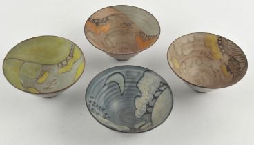 Tessa Fuchs (British, 1936-12012), a set of four conical bowls, decorated with seasonal landscapes,