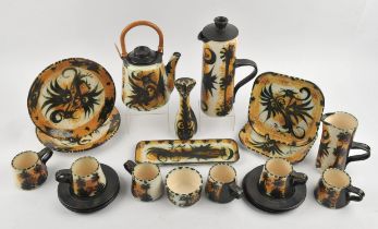 Celtic pottery, a tea and coffee set, decorated with pheonix and plants on an orange ground,