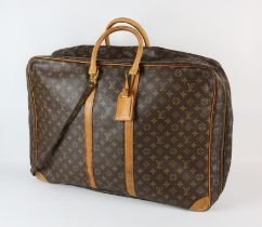 A LOUIS VUITTON large travel bag/suit carrier with luggage label, long strap and padlock (No key