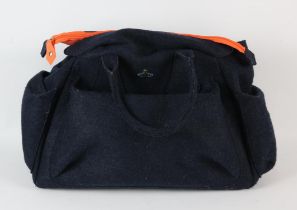 VIVIENNE WESTWOOD A black felt hold-all bag with orange lining Part of a collection belonging to