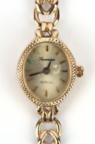 Sovereign A Ladies oval cased gold wristwatch the signed dial with bton hour markers within an