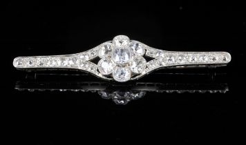 Old cut diamond bar brooch, with central floral motif, with an estimated total diamond weight of 4.