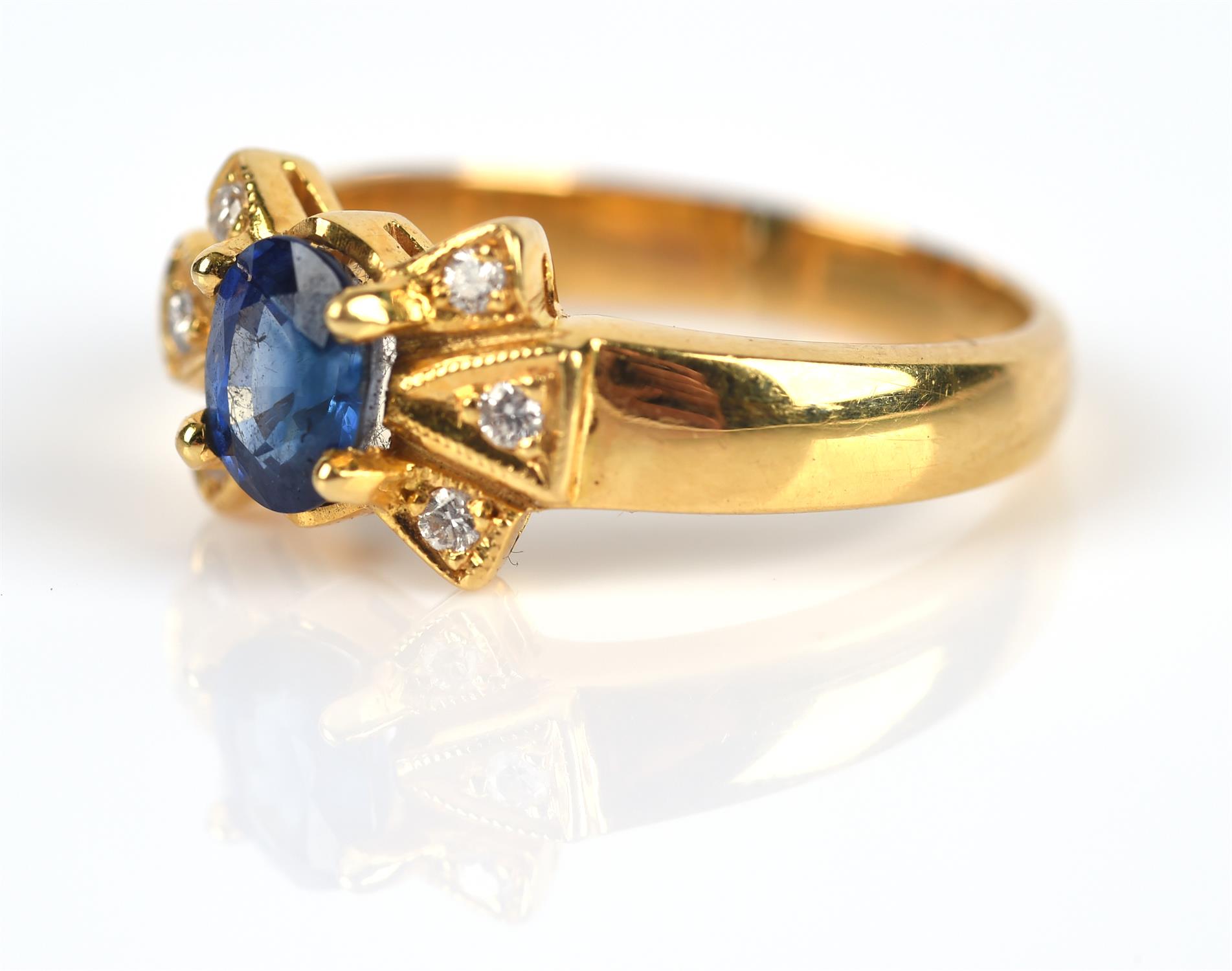 Modern sapphire and diamond ring, central claw set oval cut sapphire weighing an estimated 0. - Image 2 of 5
