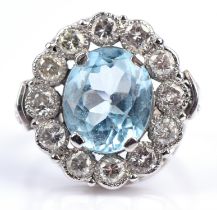 A topaz and diamond cluster ring, oval cut blue topaz weighing a estimated 6.50 carat,