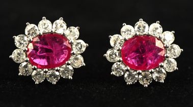 Ruby and diamond floral cluster earrings, central oval cut ruby weighing an estimated 2.25 carats,