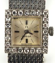 Omega, A Ladies Gold wristwatch, the diamond set bezel surmounting a silvered signed dial with