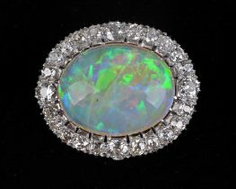 Opal and diamond brooch, with central oval cabochon opal weighing an estimated 11.14 carats,