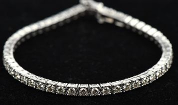 Diamond line bracelet set with 52 round brilliant diamonds in illusion settings, with a total