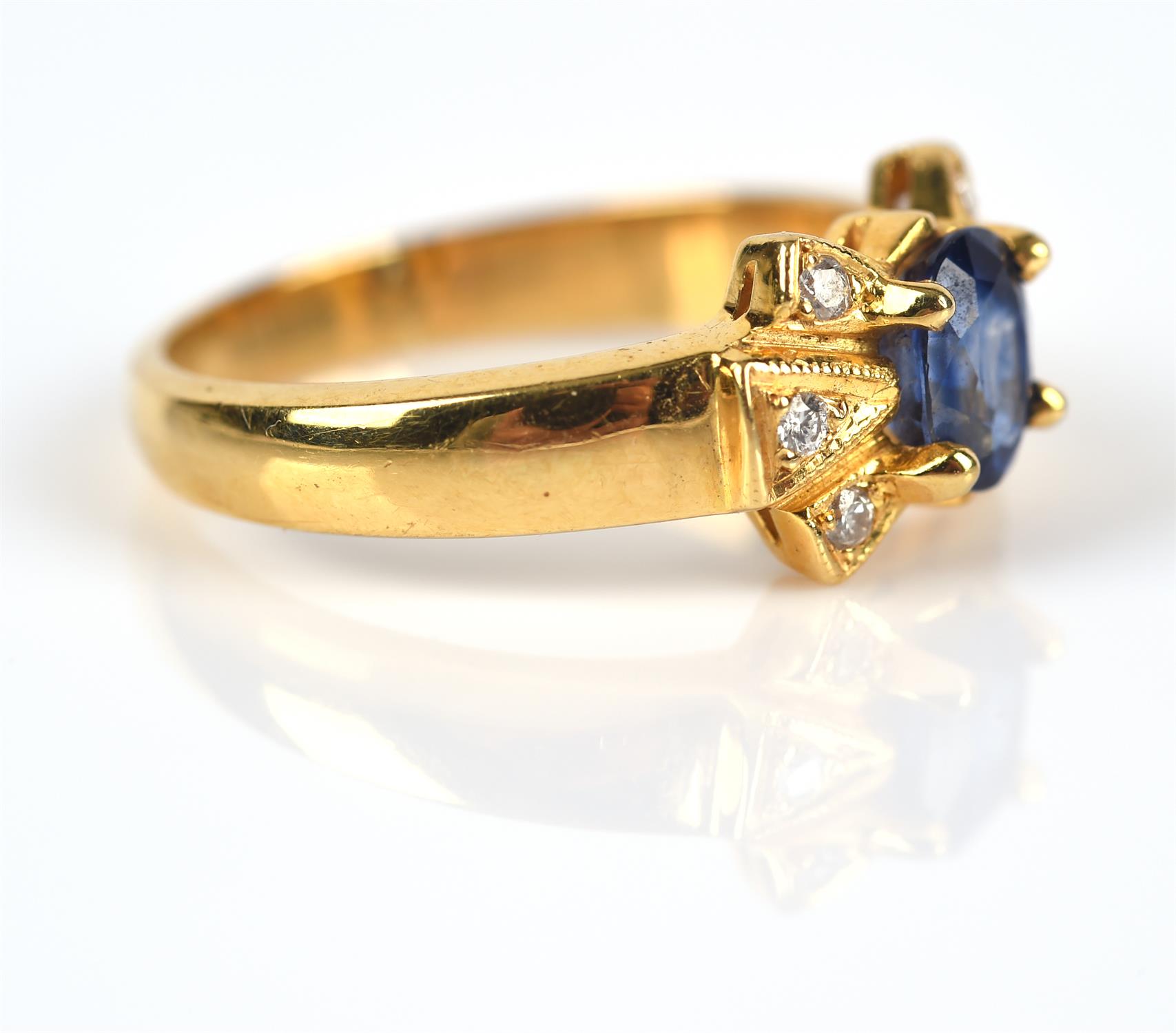 Modern sapphire and diamond ring, central claw set oval cut sapphire weighing an estimated 0. - Image 3 of 5