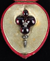 Late Victorian foil backed cabochon cut garnet pendant, set with rose cut diamonds in central