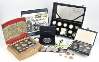 A small collection of uncirculated coins and medallions, including a British silver proof coin set