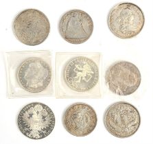 A small collection of four silver coins and five replica coins, comprising a US silver dollar 1921