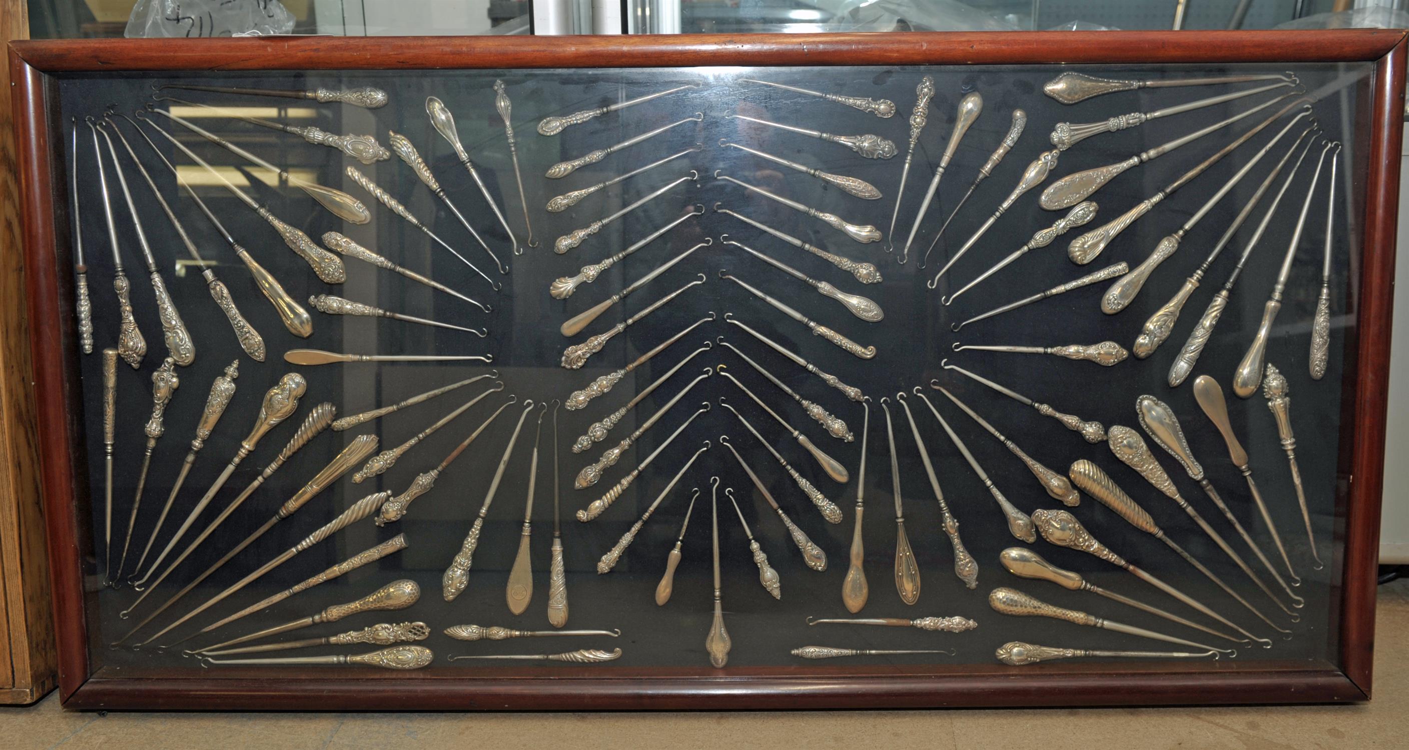 Three display cases, late 19th Century, displaying a large collection of silver button hooks, - Image 2 of 4