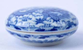 A blue and white circular box, decorated with a coiled dragon; 8.5 cm wide; the base with Qianlong