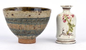 A large stoneware bowl on a circular, unglazed foot; with a Temokku-style glazed interior,