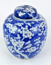 A blue and white prunus jar with domed cover