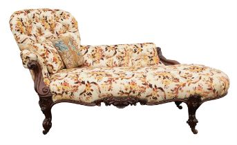 Victorian walnut chez longue, upholstered in floral flock fabric on scrolling legs with castors,