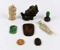 Eight various stone carvings, including: a small circular plaque with a Buddhist deity on the