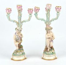 Pair of Dresden four light candelabra each with an allegorical figure of a cherub,