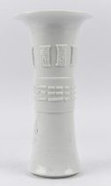A Blanc-de-Chine vase with trumpet neck, decorated with linear trigrams [presumably from the