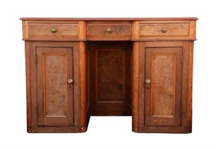 A Victorian walnut and burr walnut dressing table, with rounded corners, the panelled kneehole