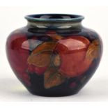 Moorcroft pomegranate and grape vase, of squat ovoid design, height c6.5 cm. Impressed marks,