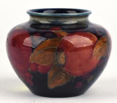 Moorcroft pomegranate and grape vase, of squat ovoid design, height c6.5 cm. Impressed marks,