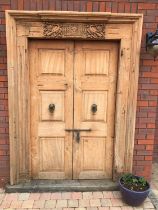 Indian carved teak door and frame, with a moulded three section outer surround, the central cornice